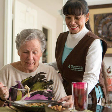 Caregiver serving dinner to client