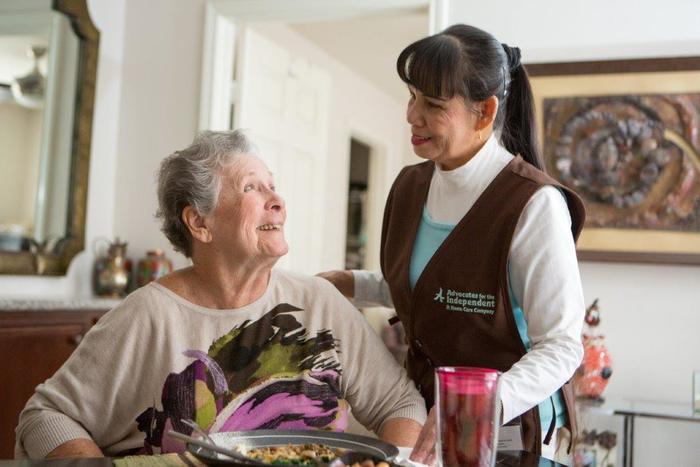 Caregiver with client at mealtime