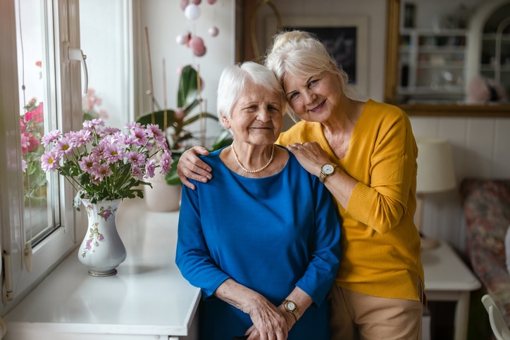 Woman hugging her elderly mother